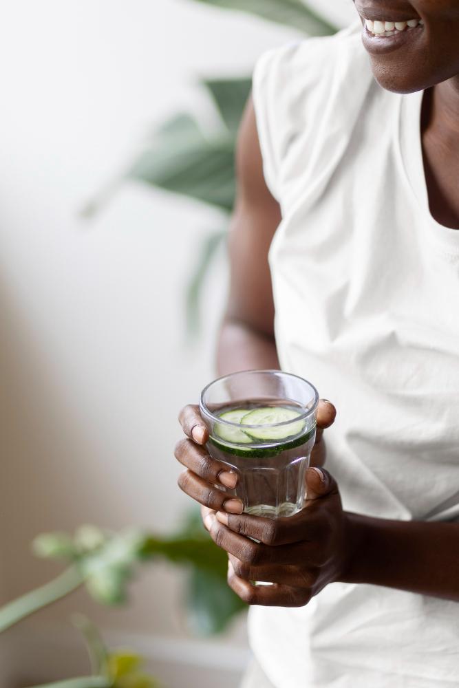 person keeping themselves hydrated with citrus water